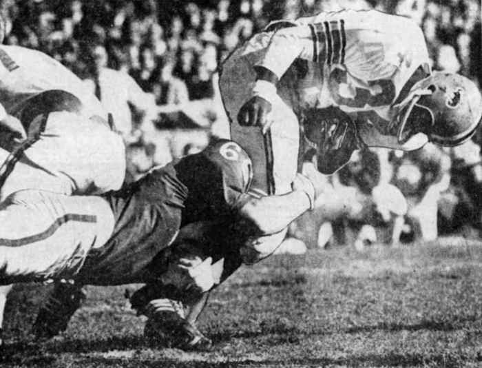 Wayne Meylan wraps up OSU fullback Jack Reynolds.